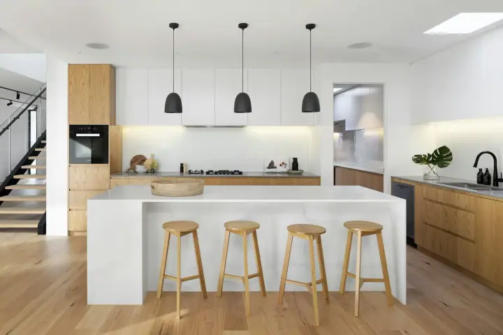 White kitchen with an island and pendant lights